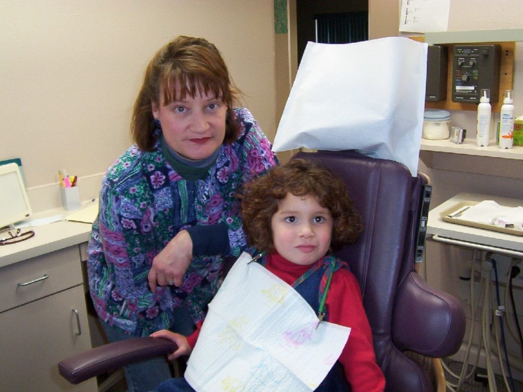 kid and dentist in dentist office